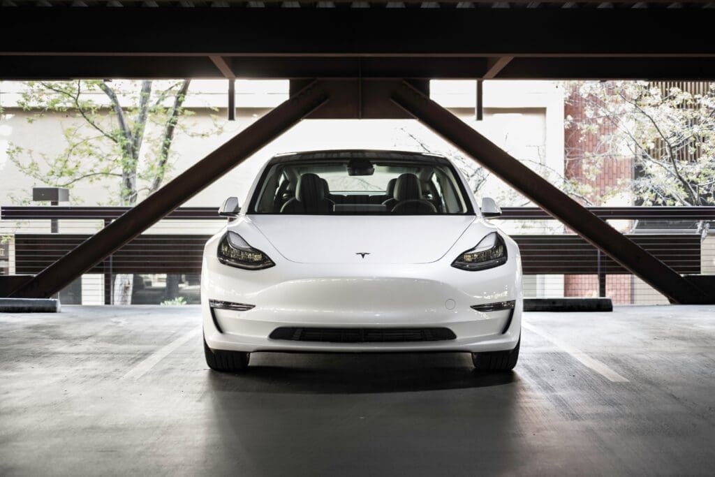 White Tesla parked under structure
